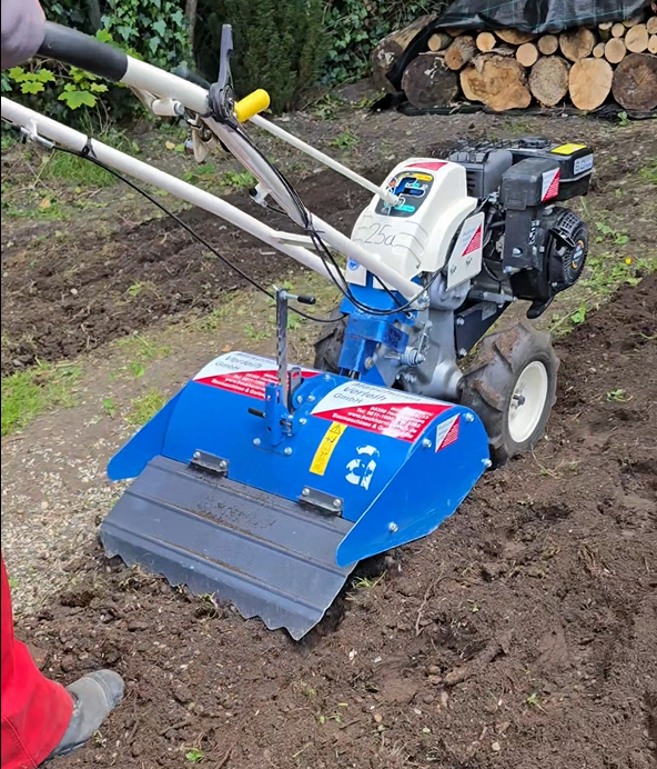 Die Gartenfräse beim Umfräsen von Erde