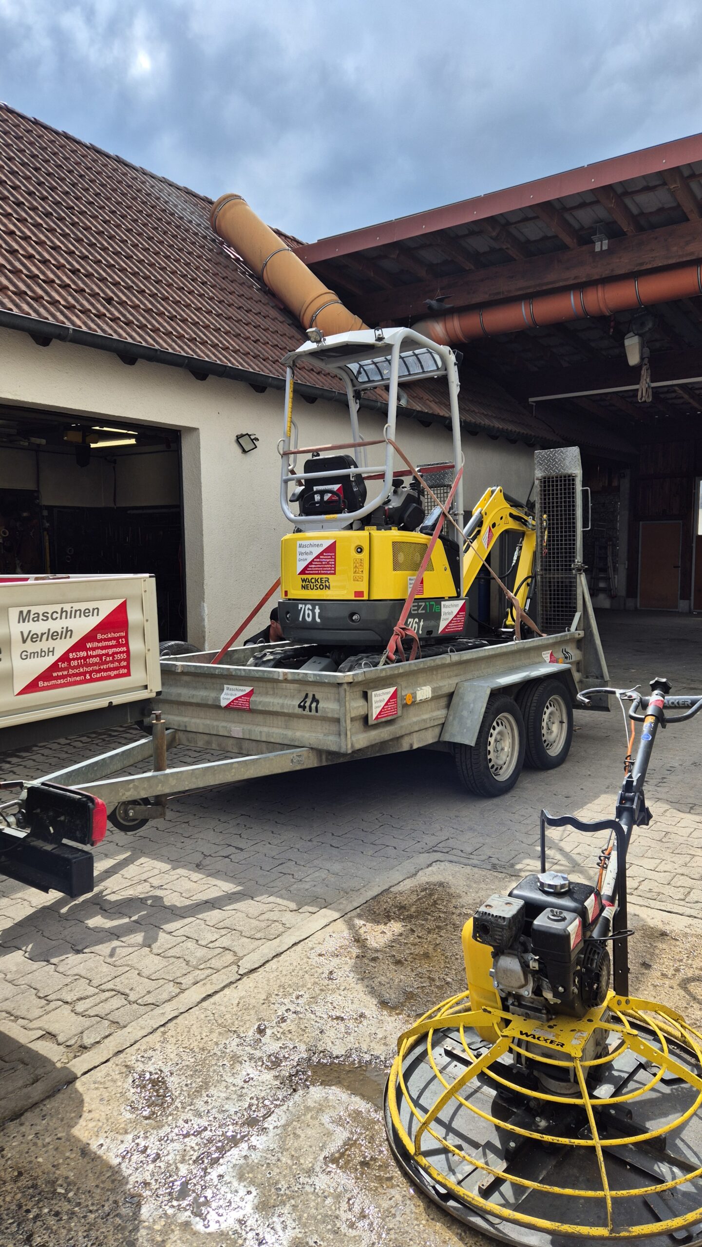 Der Minibagger steht auf einem Anhänger verladen